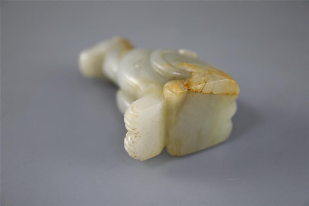 A Chinese pale celadon and russet jade figure of a mythical beast, 7.5cm high